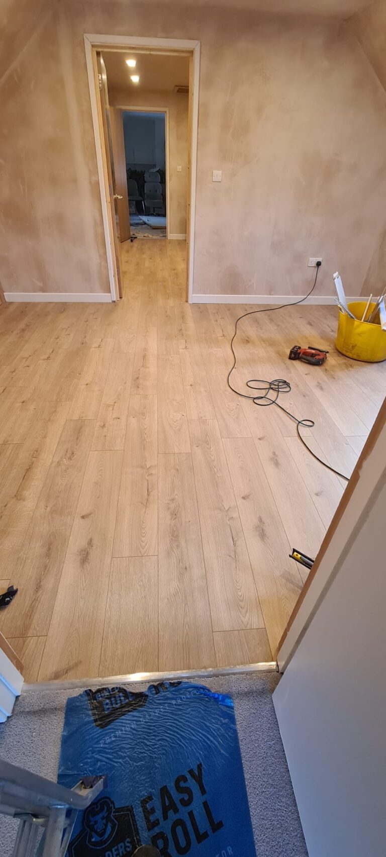 new wood-effect flooring fitted in a loft room during renovation