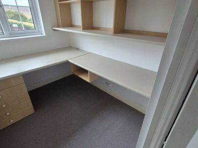 Services 11 built-in desk and shelving in a bright upstairs room